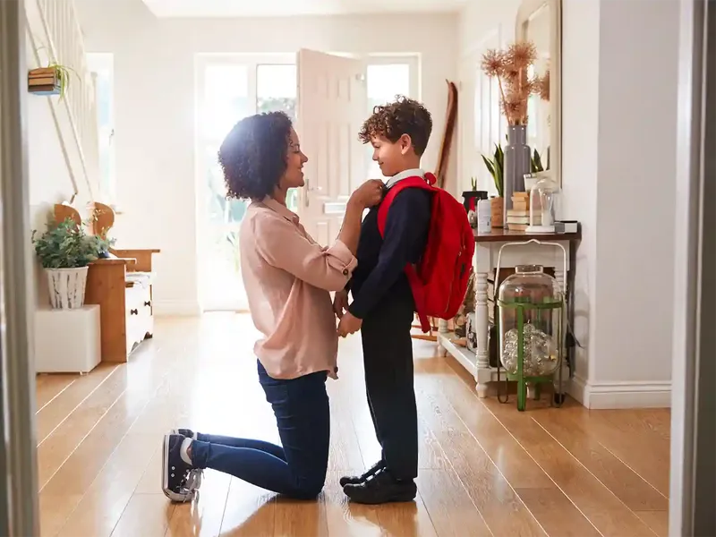 mum and son ready for school after moving home to be in the right catchment area