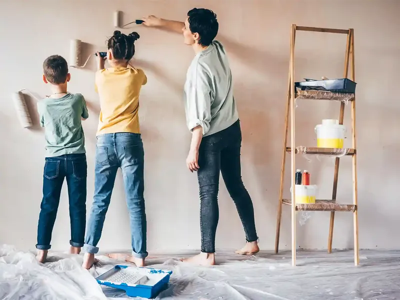 family painting a room to get their house ready to sell