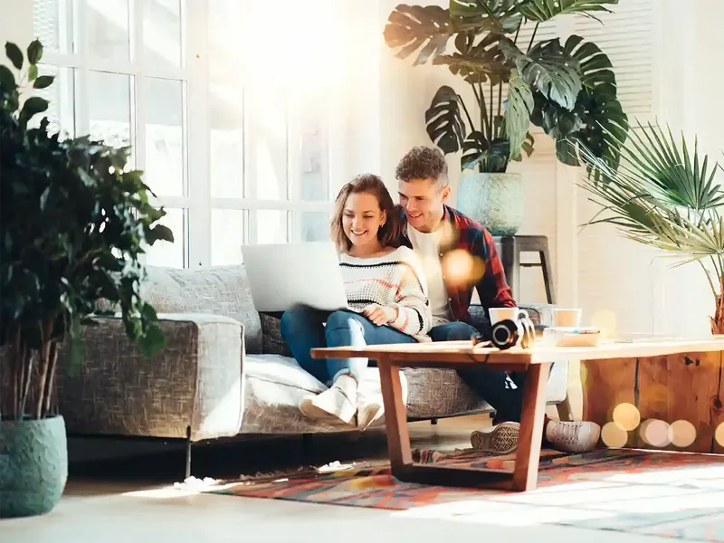 couple looking at online conveyancing quotes for their first house purchase