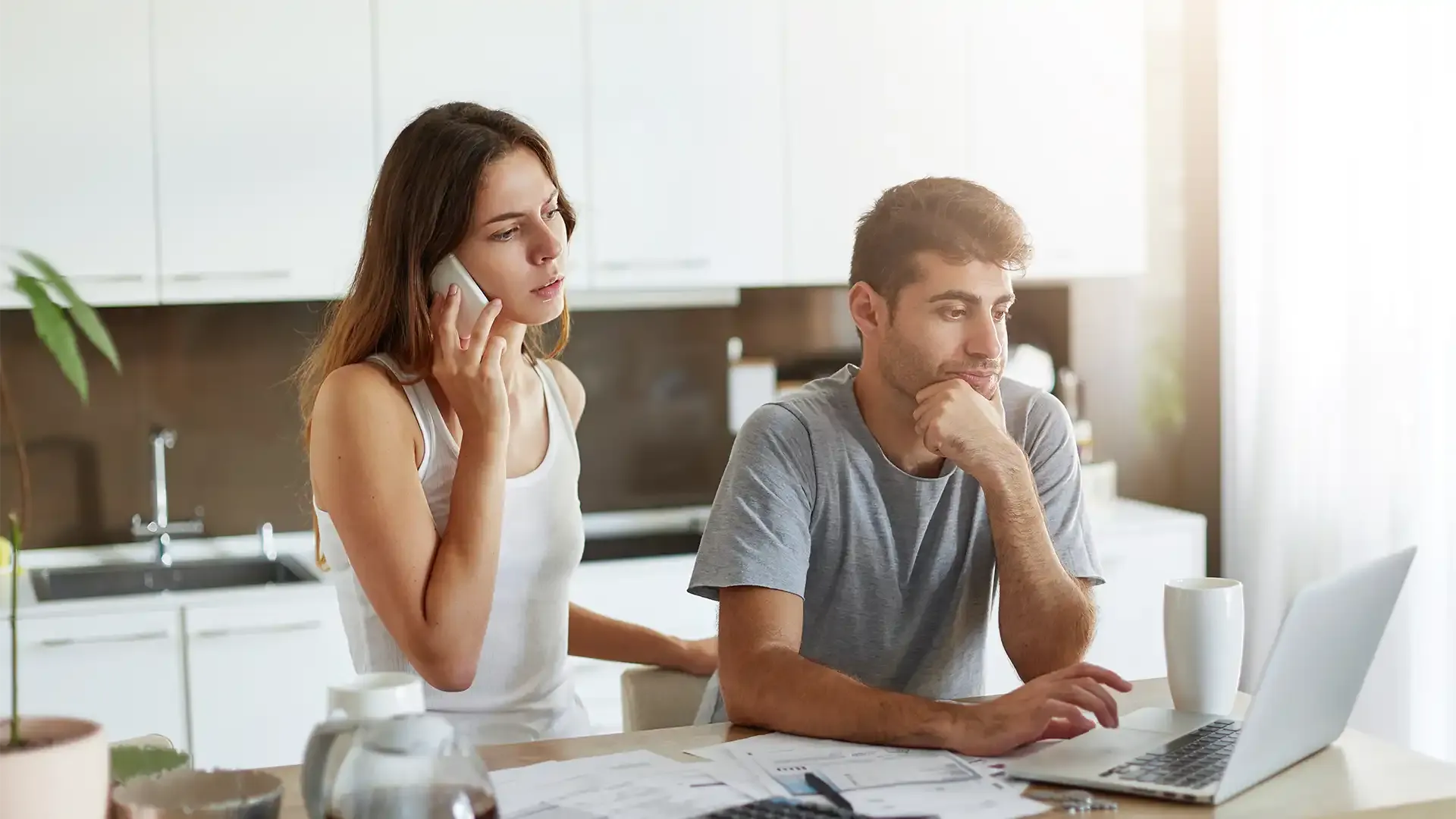 young woman working out the costs and fees to sell her flat so she can move in with her boyfriend