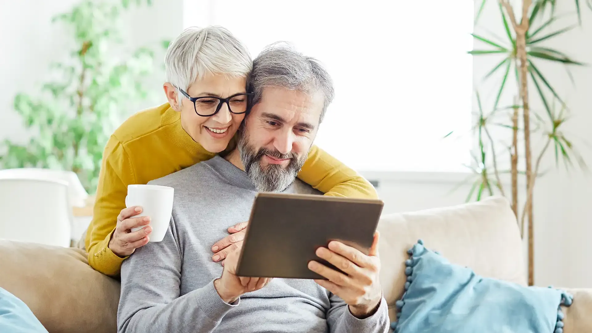 couple looking online at remortgaging deals to work out whether they should remortgage to release equity from their house