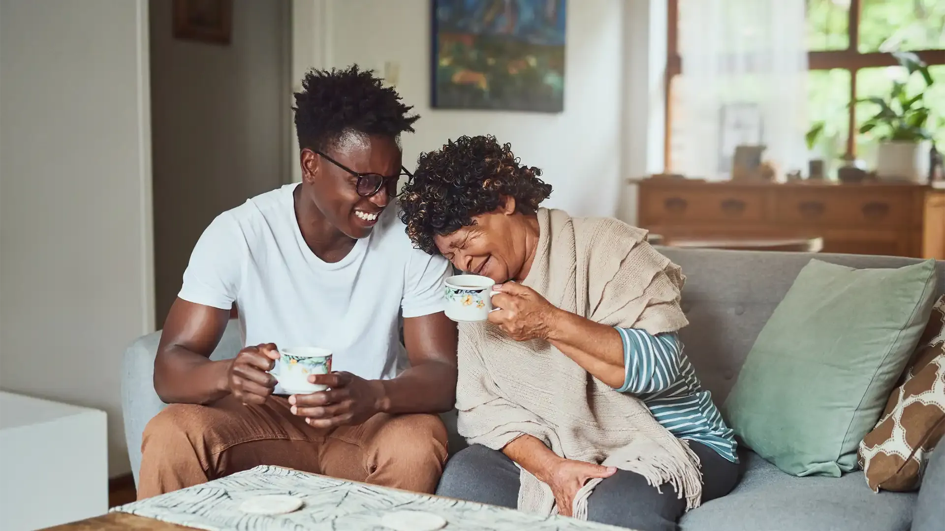 grandmother and grandson having a cup of tea after looking at the process to release equity