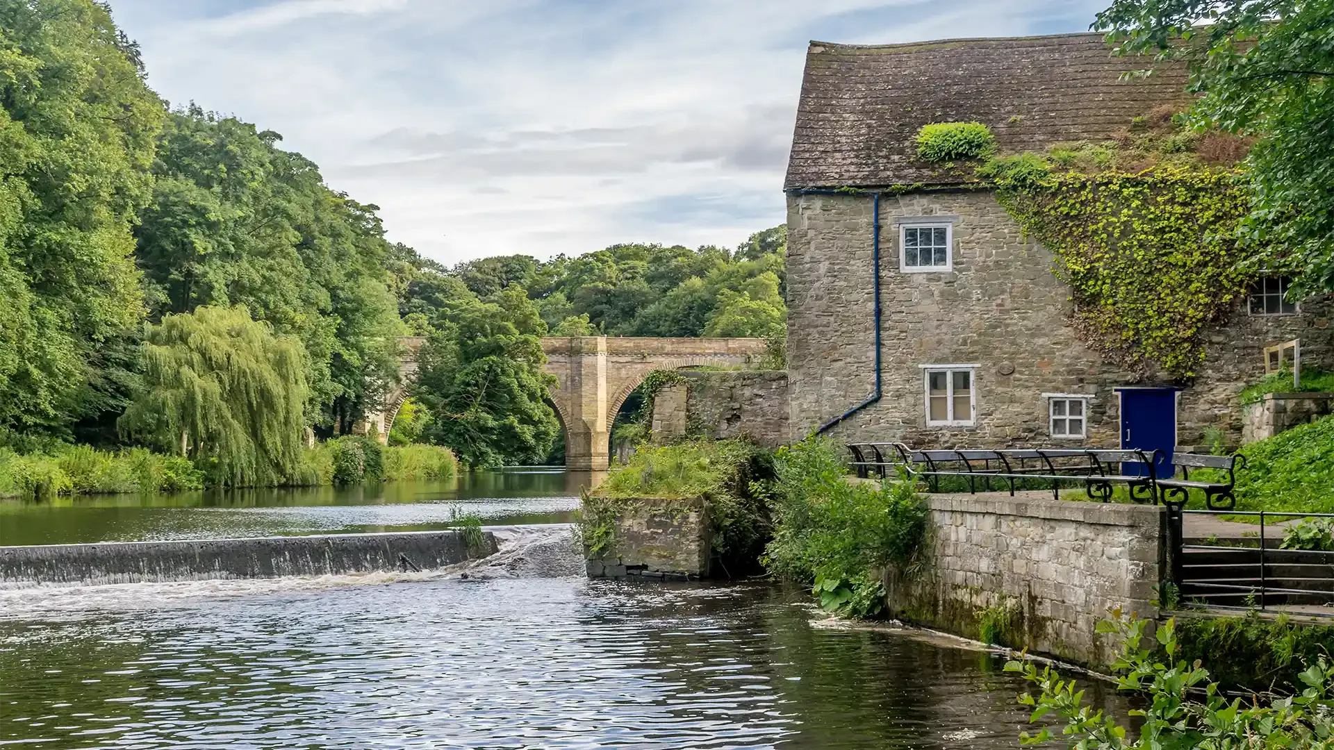 picturesque boat houses and a bridge next to the river Wear
