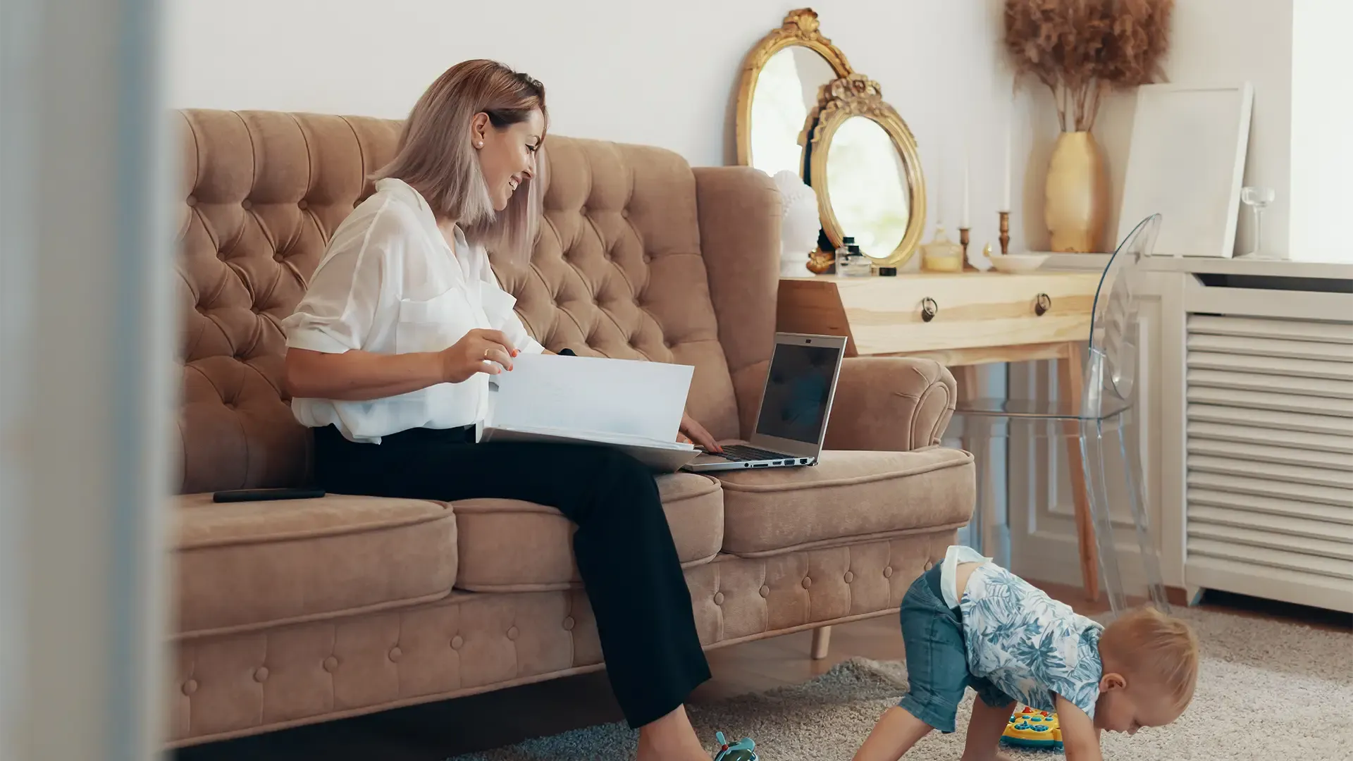 a mum with her son looking on her laptop to see how much she can afford to pay for a new house