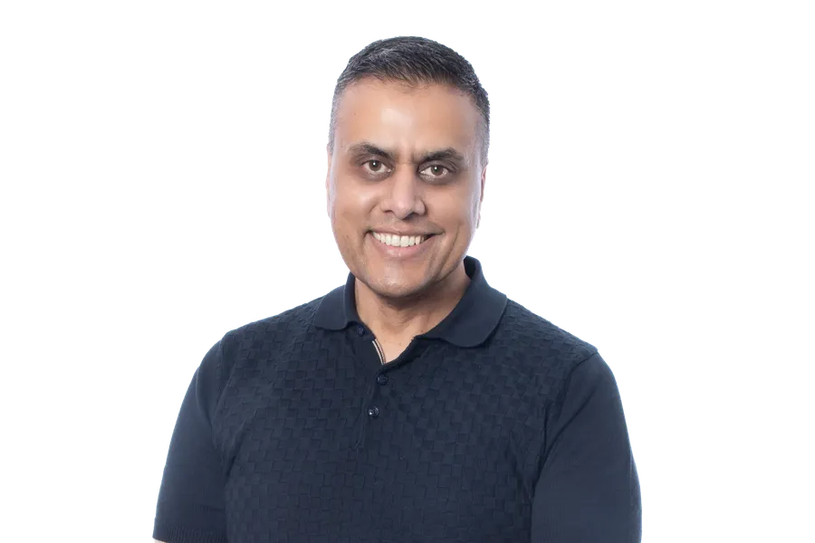 Smiling person in a navy polo shirt