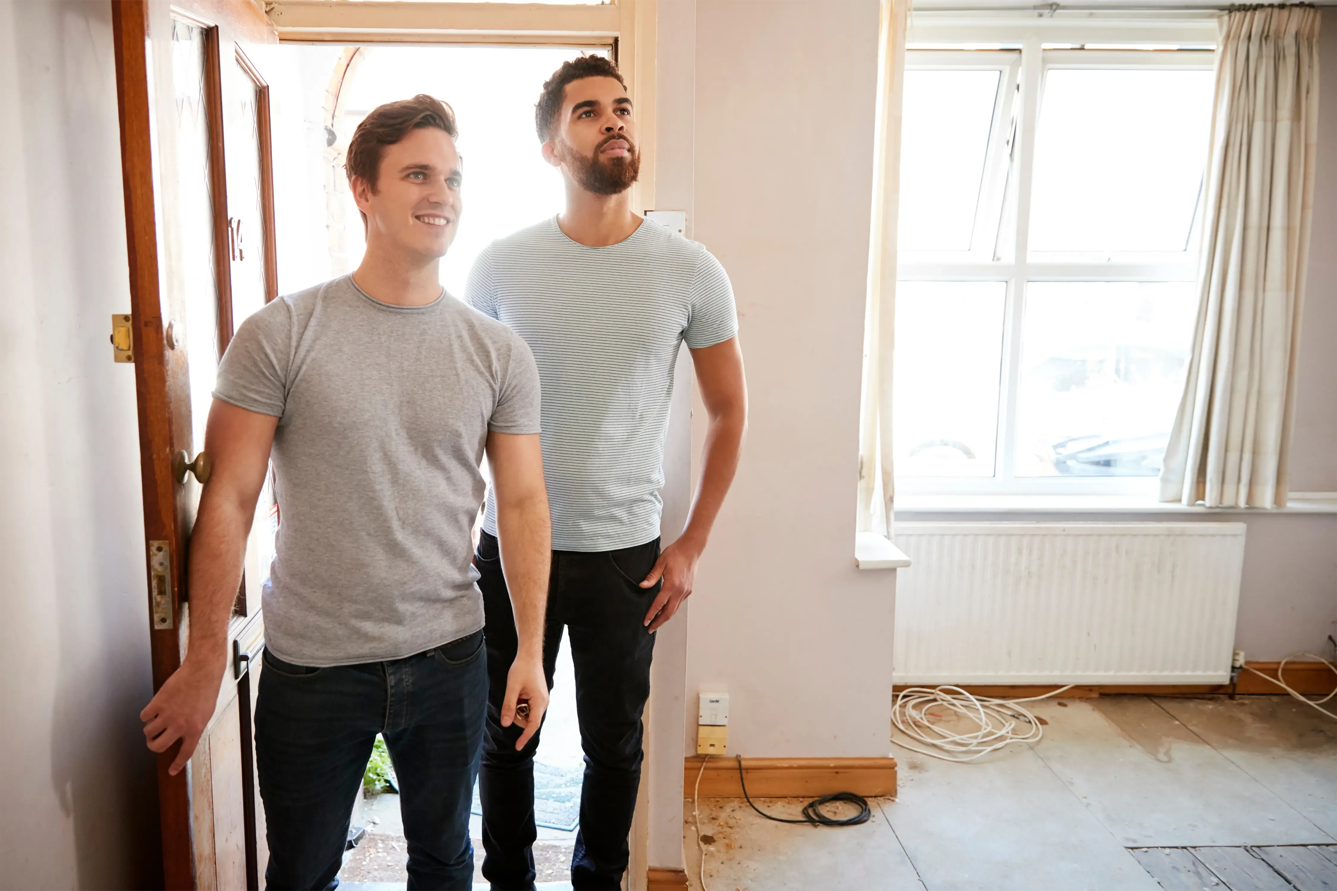 two friends looking around a house they want to buy together