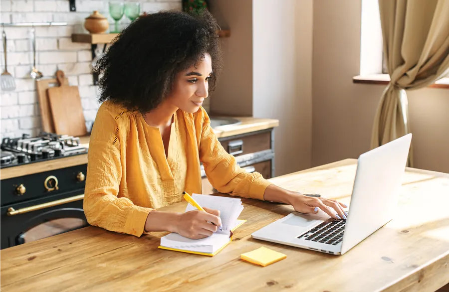 young woman going through her moving house checklist before completing on her first house purchase