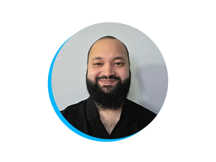 Man with a beard smiling, wearing a black shirt. Background is a light gray with a blue circular border design.