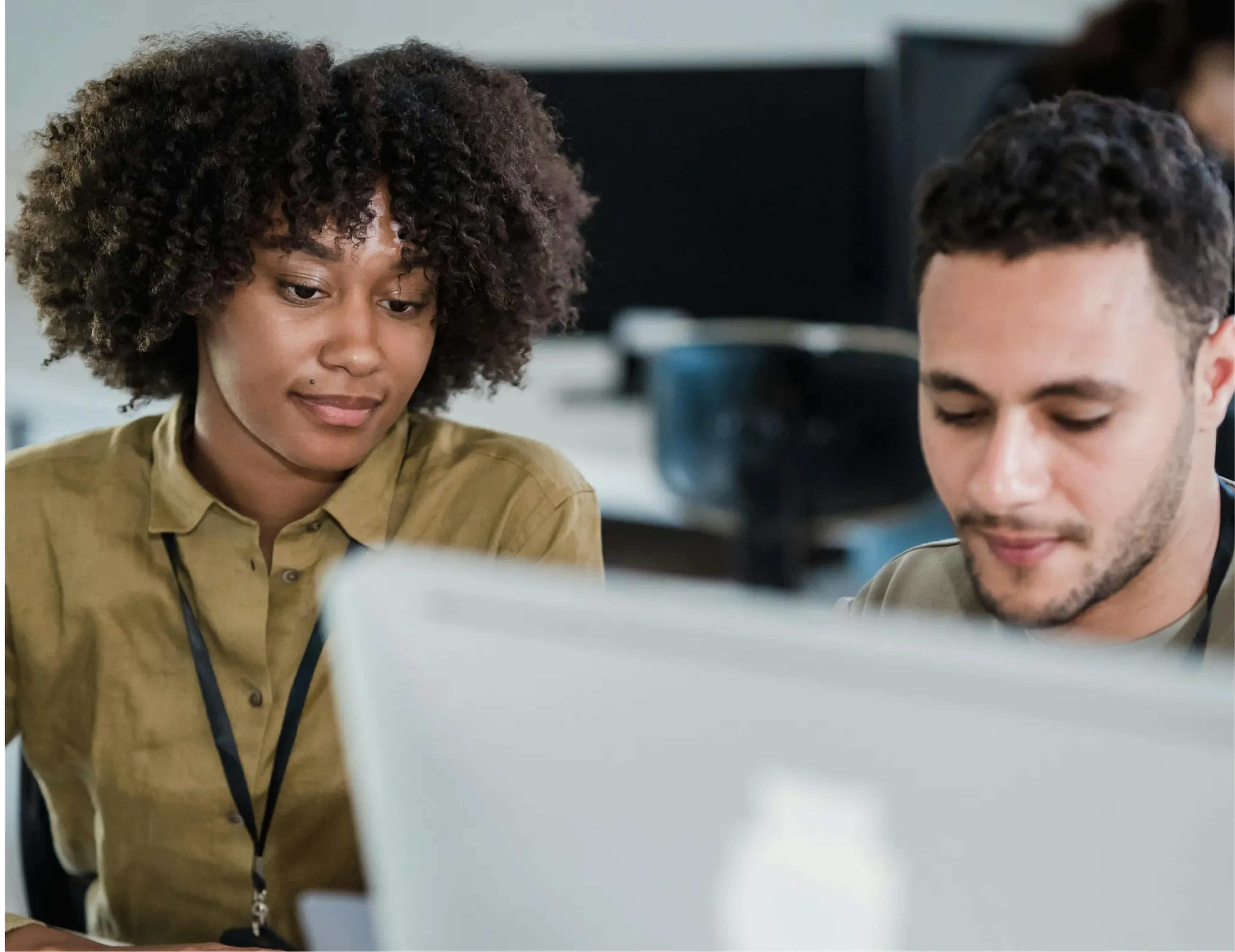 Two people in front of a computer at work