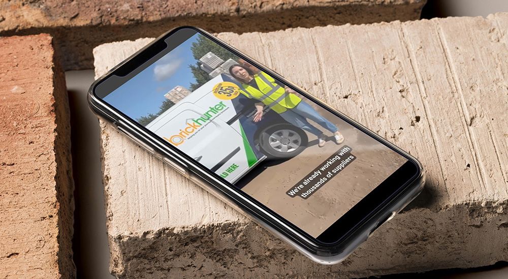 Smartphone showing video content on top of a brick