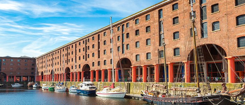 Exterior view of the Royal Albert Dock in Liverpool with boats on the water