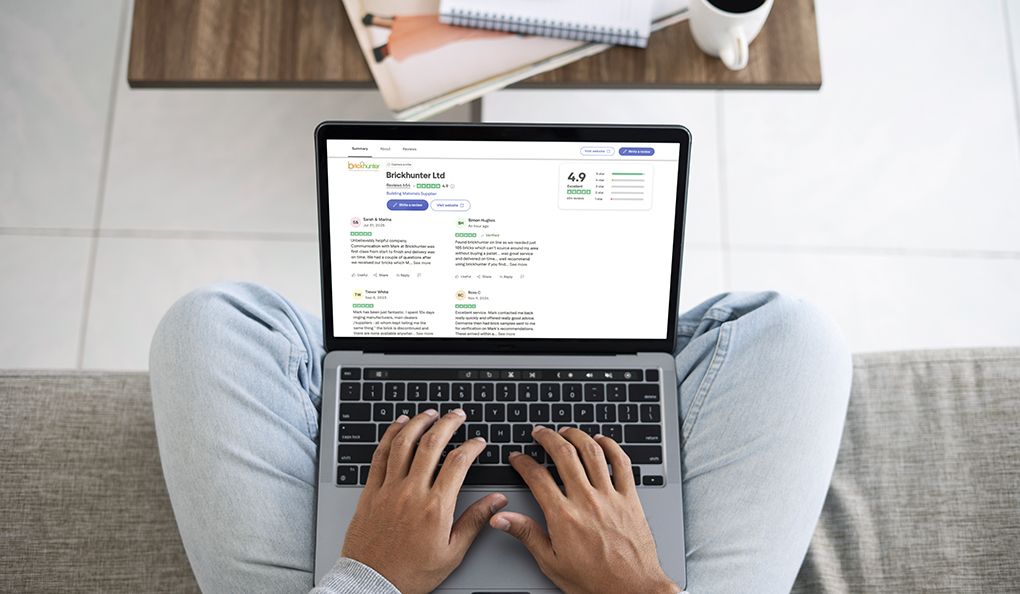 A man reading brickhunter.com's trustpilot reviews on a laptop