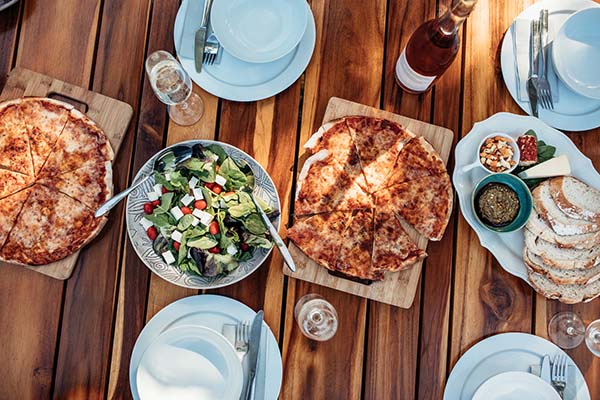 Top view of party food and drinks on wooden table