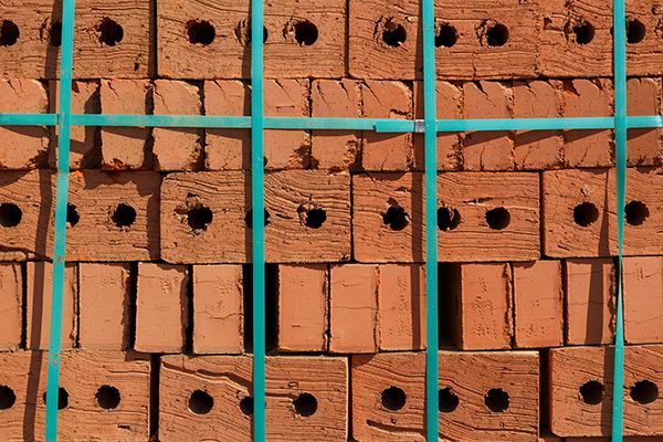 Stack of clay bricks secured with fastening tape