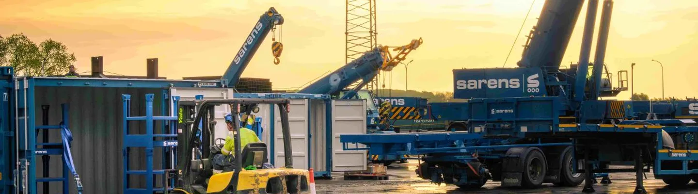 Sarens compact crane and lifting equipment on site at sunset