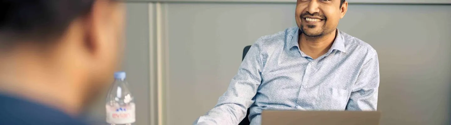 Sarens employee working at a desk in an office environment