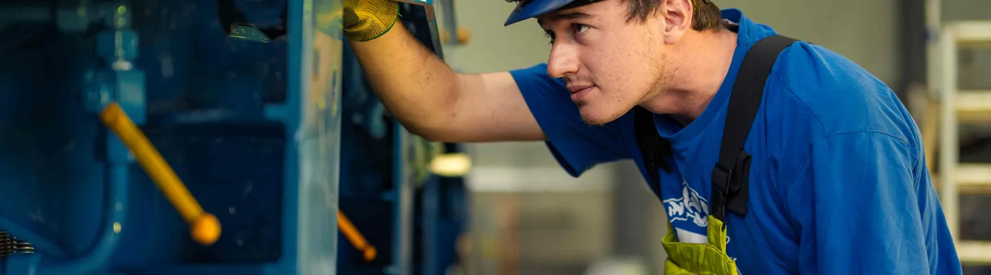 Sarens employee inspecting heavy lifting equipment in an industrial environment