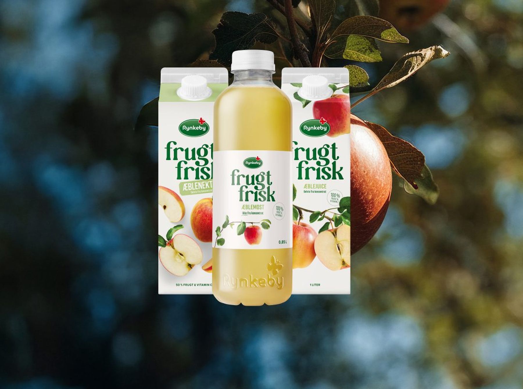 Rynkeby Frugt & Frisk apple juice bottle and cartons with an apple tree background.
