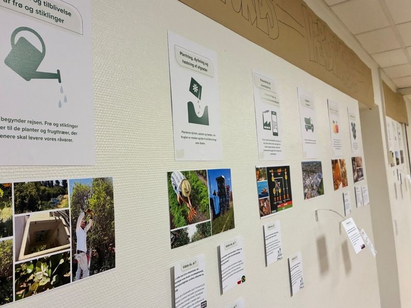 A wall display with various images, diagrams, and informational sheets related to agriculture and gardening, including photos of farming activities.