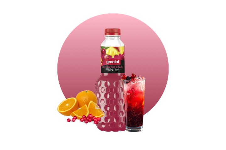 A bottle of Granini "Sex on the Beach" non-alcoholic cocktail, surrounded by oranges and berries, next to a pink cocktail on ice.