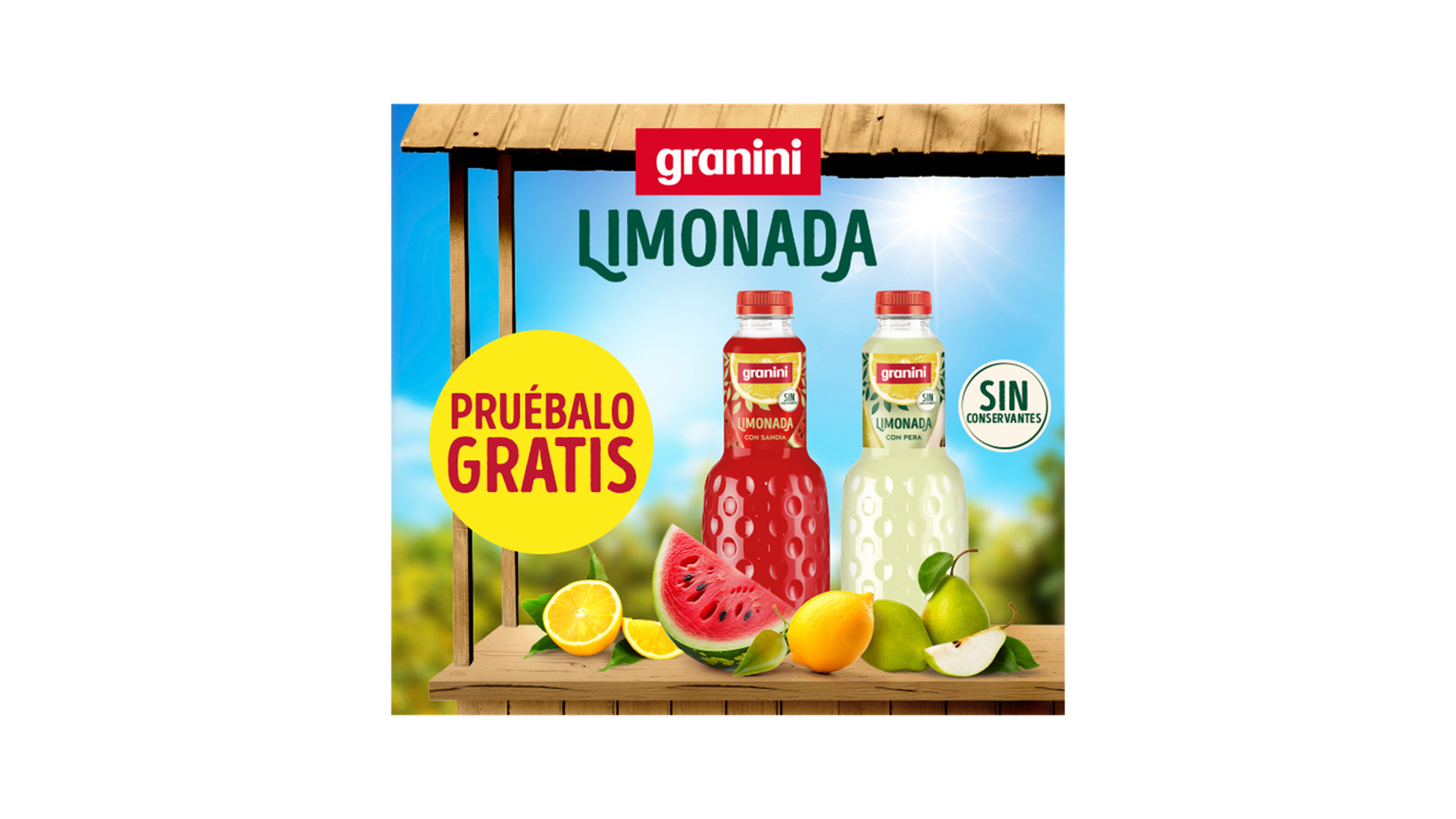 Bottles of Granini lemonade, one watermelon-flavored and one lemon, on a wooden shelf with fruit. Text: "Prúebalo Gratis" and "Sin Conservantes."