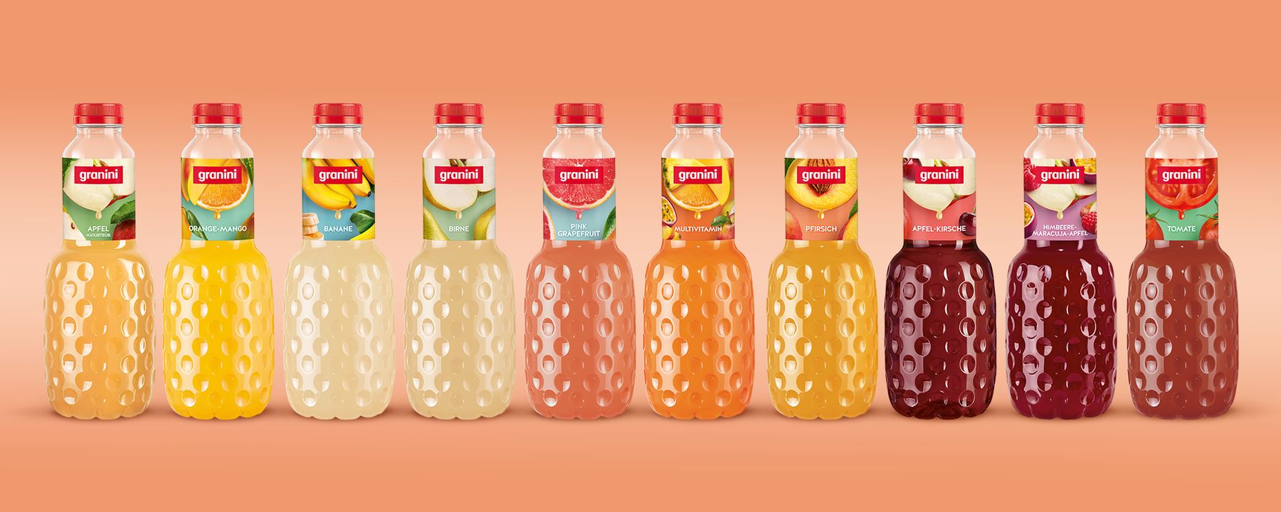 Ten Granini juice bottles in a row, featuring various flavors like orange, pineapple, and apple-cherry, on an orange background.