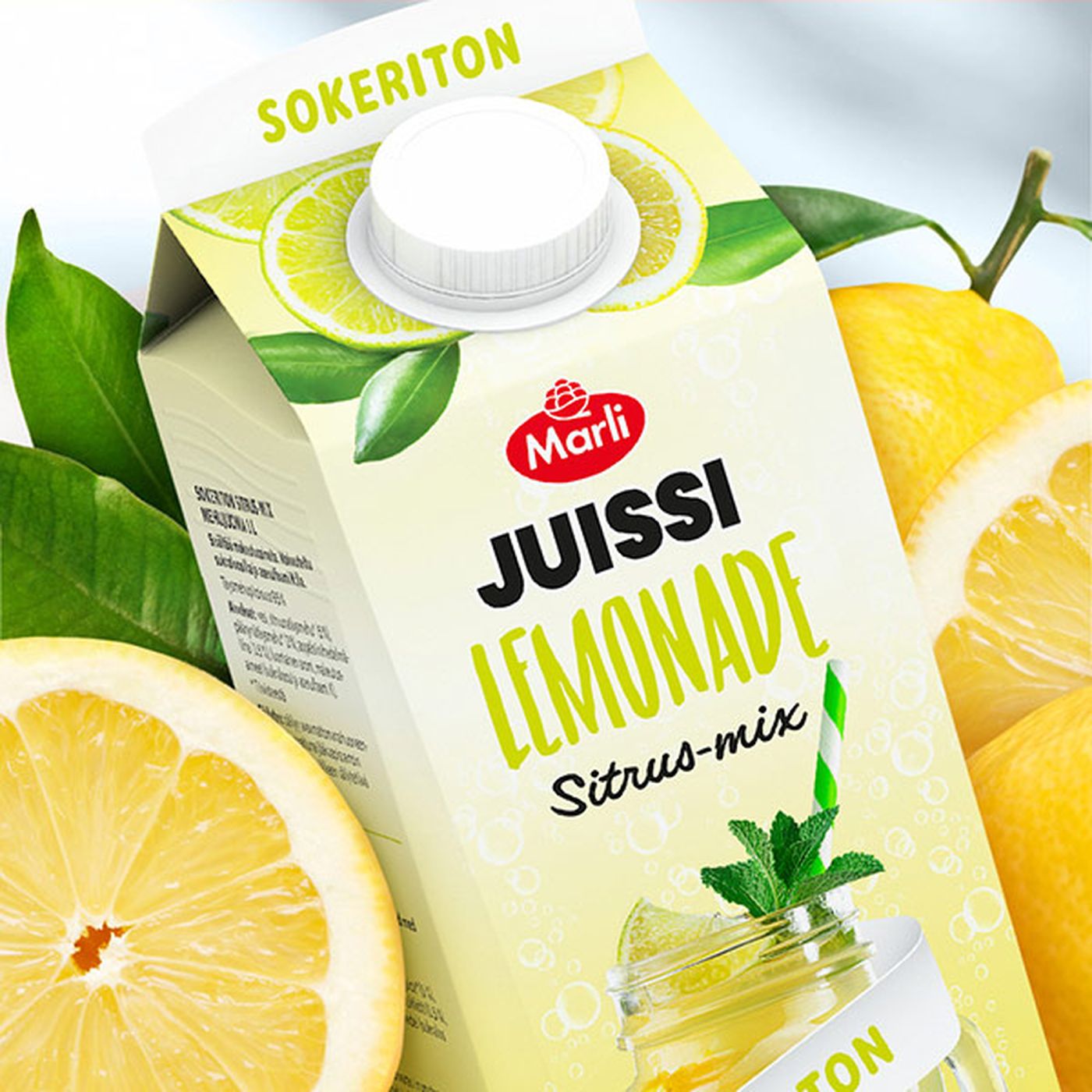 Carton of Marli Juissi Lemonade Sitrus-mix featuring lemons and mint, with the word "Sokeriton" on top, surrounded by fresh lemons and leaves.