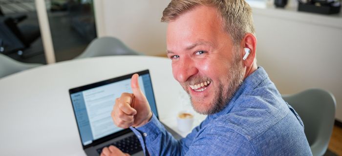 Jan Blankenhorn am Laptop, Daumen hoch, Webinar Kundenportal für B2B