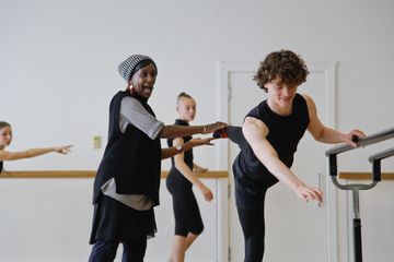 An image of a ballet student encouraged by ballet teacher