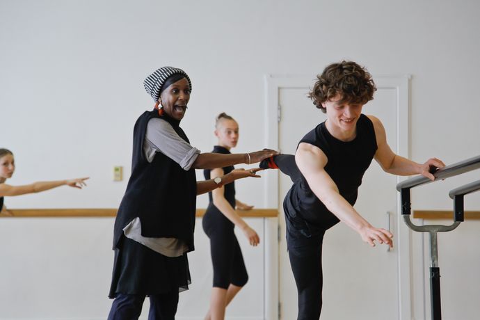 An image of a ballet student encouraged by ballet teacher