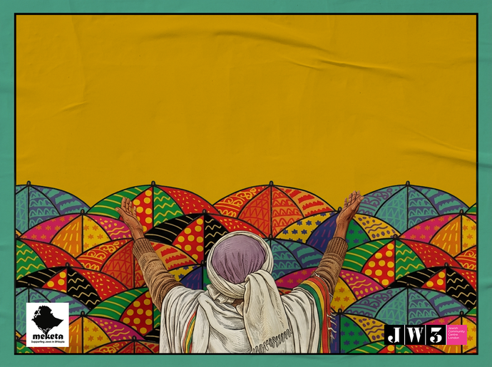 Person with raised arms stands before a vibrant display of colourful umbrellas and artwork.