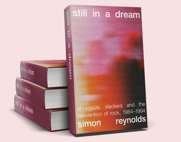 Pile of 3 books with one facing front. Pink and orange blurry cover with words 'still in a dream'