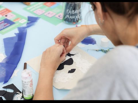 close up over someone's shoulder as they create artwork