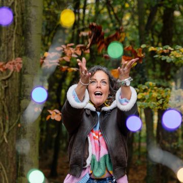 Person plays with lights in a forest
