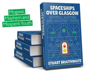 Pile of 3 books with one facing front. Blue cover with geometric white lines forming a pattern of a room
