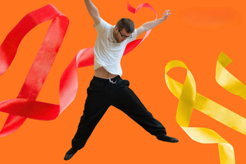 Man in mid-air pose against an orange background, surrounded by flowing red and yellow ribbons.