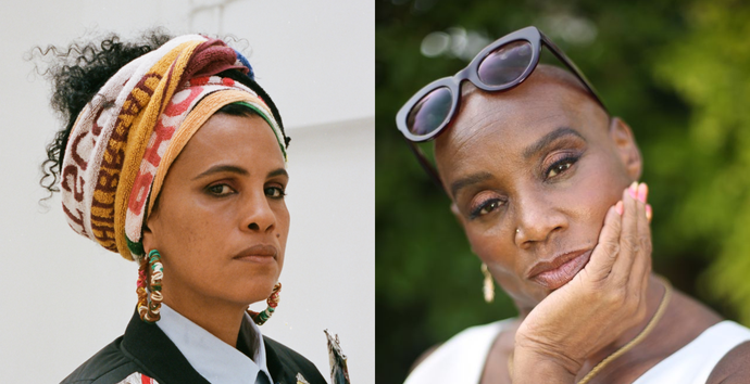 Two women - one on left wearing hair scarf and chunky fabric earrings, and on the right wearing flicked eyeliner and sunglasses on head, resting chin in hand