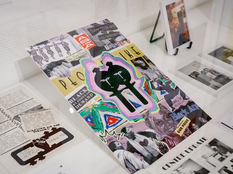 A colourful collage poster with abstract figures and cut-out images, surrounded by documents and black-and-white photographs displayed in a glass case.