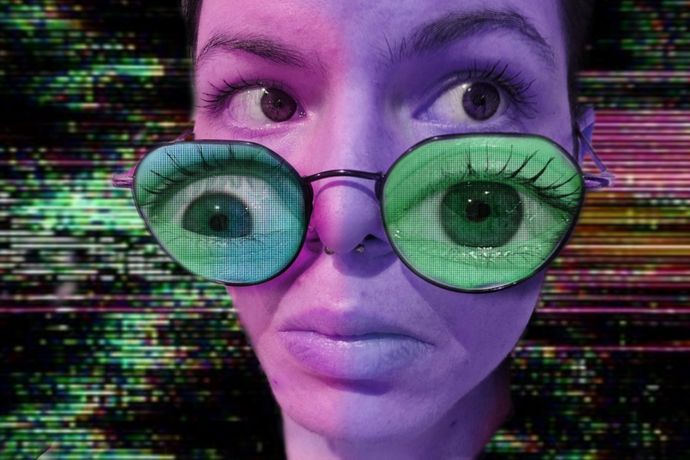 A person with large, green, superimposed eyes on sunglasses. The background is a colourful, distorted digital pattern.