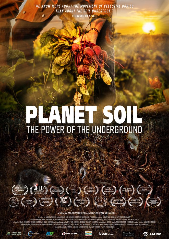 Poster for the documentary Planet Soil: The Power of the Underground featuring a person holding freshly pulled root vegetables above soil teeming with underground life, with multiple award laurels displayed at the bottom.