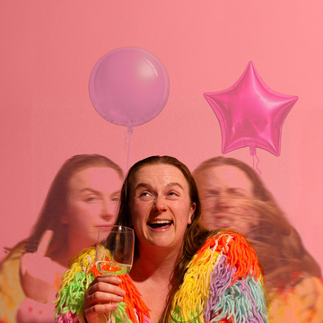 Person holding glass, surrounded by motion-blurred duplicates, colorful jacket, pink background, balloons floating behind.