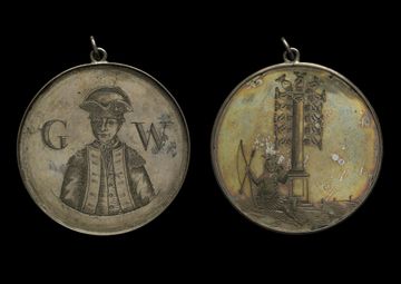 Two old medallions, worn and discoloured by time, one shows a man in military uniform with letters 'G W' and the other shows a person sitting on side holding bow and arrow