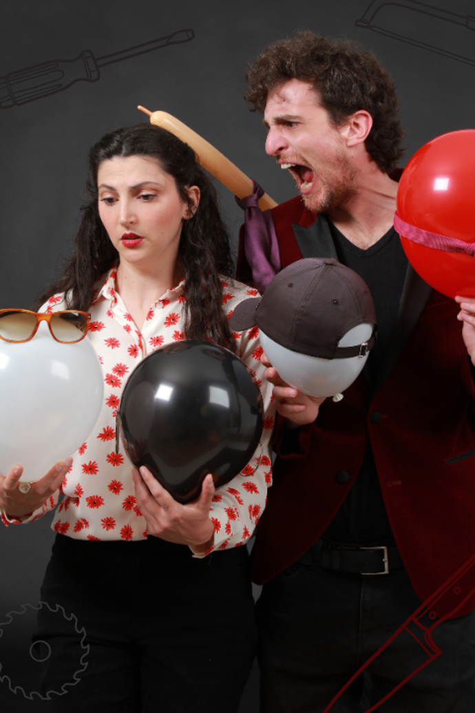 A woman and a man with balloons, sunglasses, and a hat, posed humorously; a rolling pin seemingly in the man's hair.