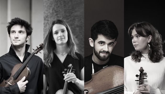 Four musicians standing side by side, each holding a string instrument including violins and a cello, against a neutral background.