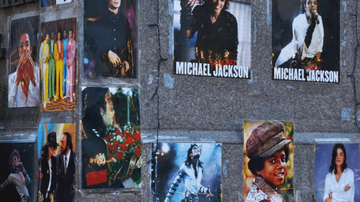 A wall display of various Michael Jackson posters, showcasing different stages and styles of his career.