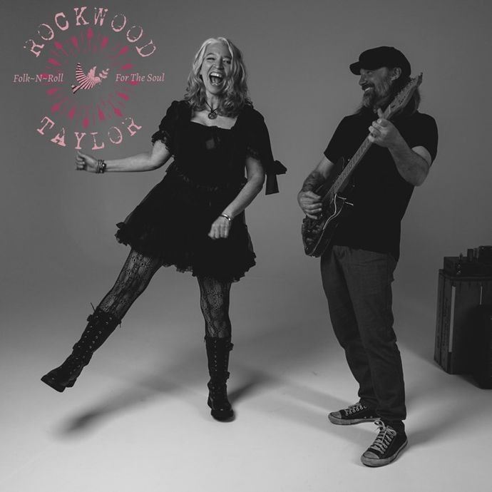 Two musicians perform together in a studio setting, with guitar playing and dynamic movement.