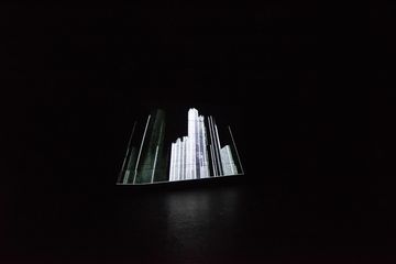 Black and white image of an illuminated city skyline