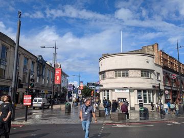 Picture of Camden high street with people walking, with a nice blue sky