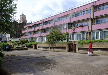 image of housing estate with pink balconies and a tower in the background