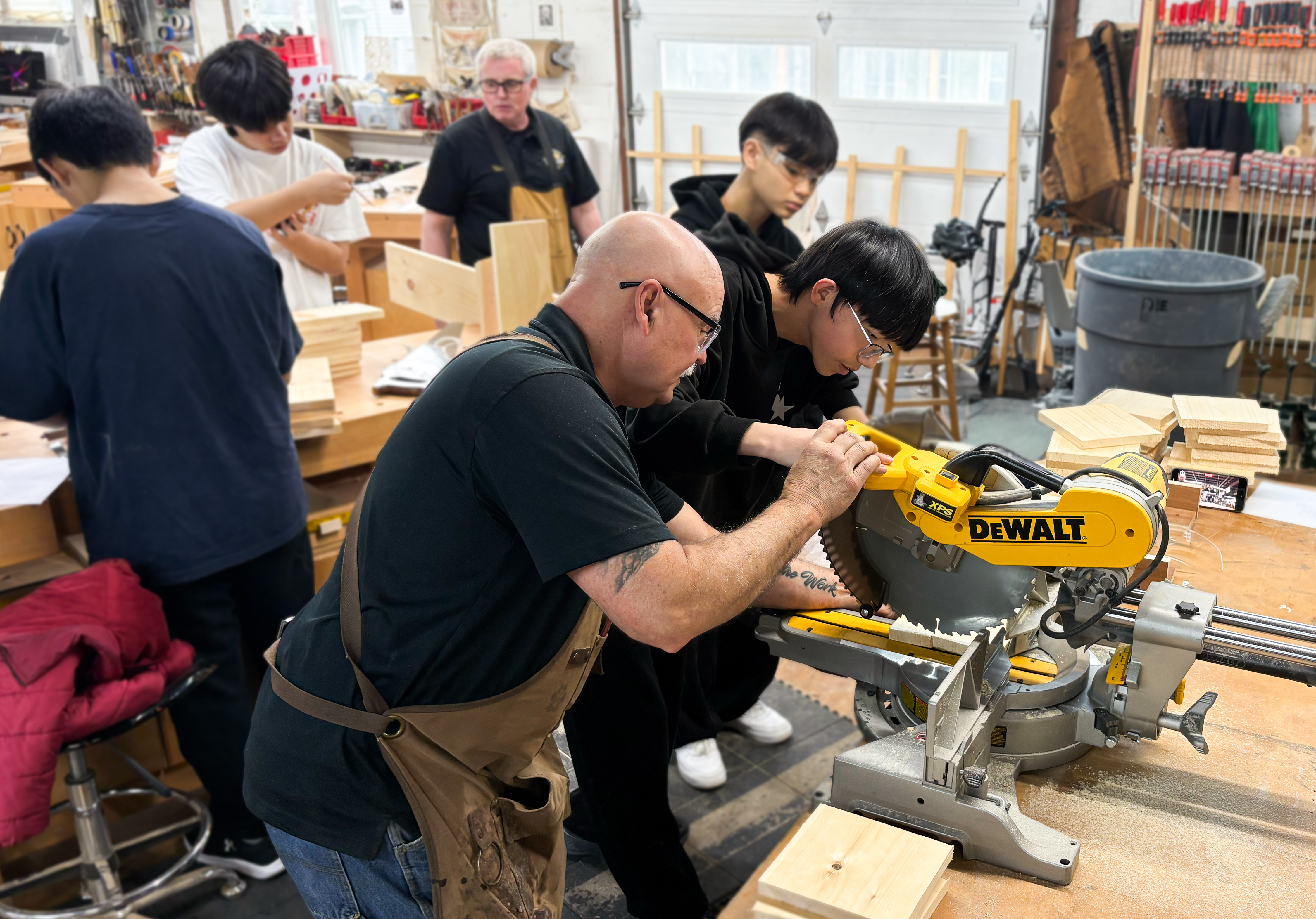 EF Academy Preparation Program students using a table saw to create birdhouses